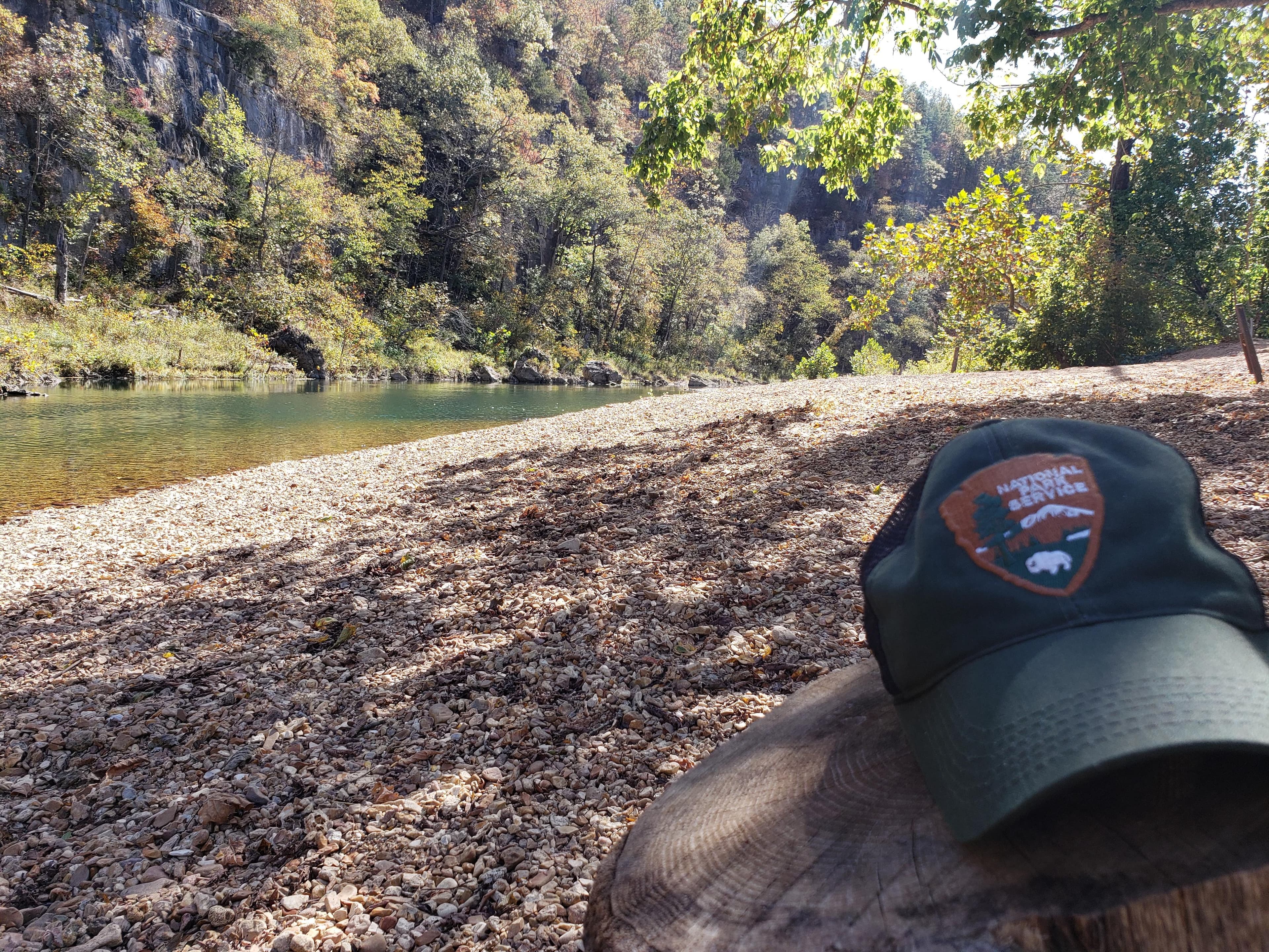 A large gravel bar with a park ranger hat in the foreground.